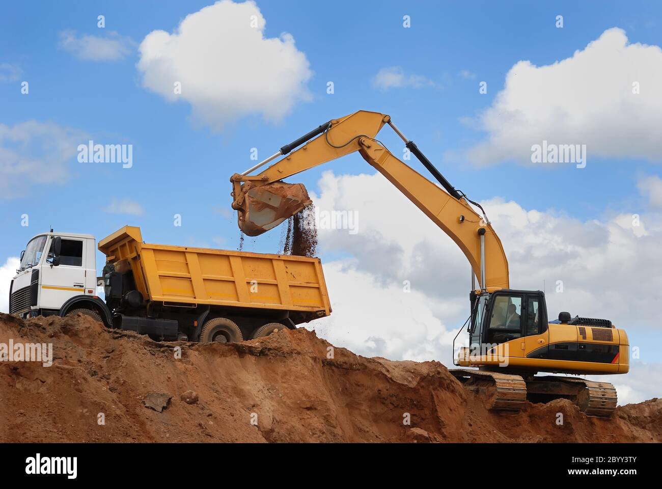 Excavator and rear-end tipper Stock Photo
