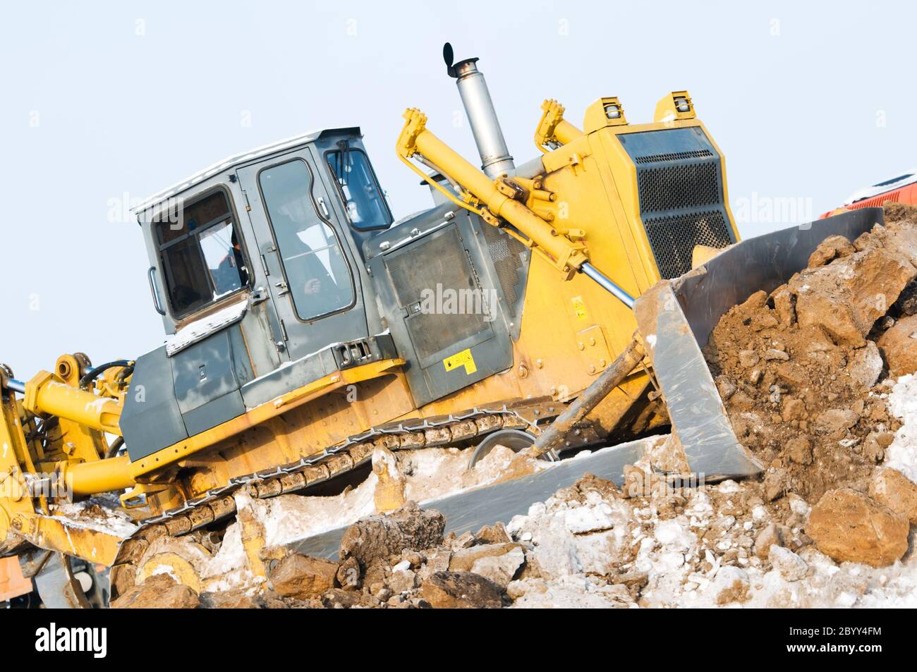 bulldozer loader at winter frozen soil excavation works Stock Photo
