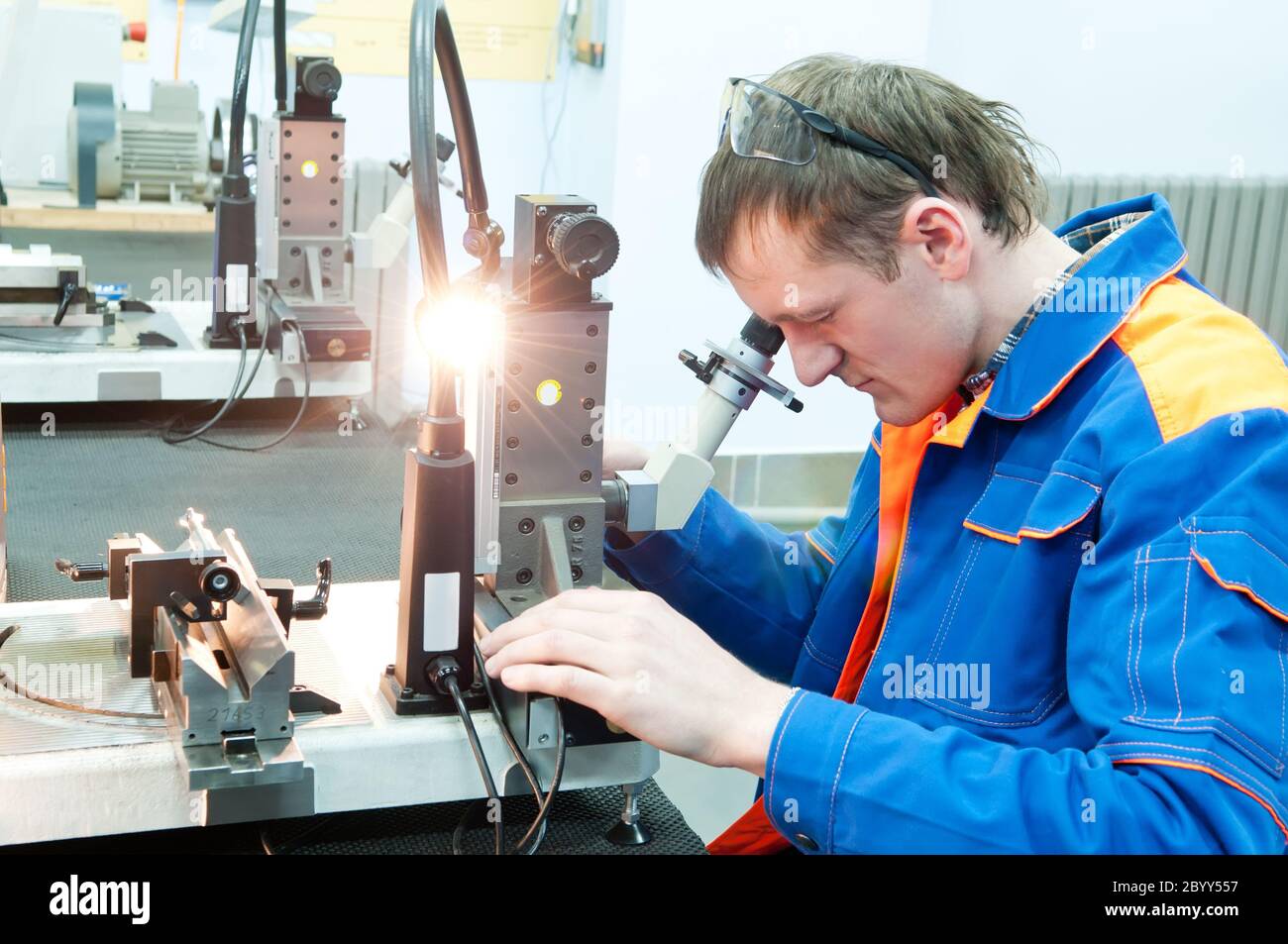 laborer checking tool with optical device Stock Photo