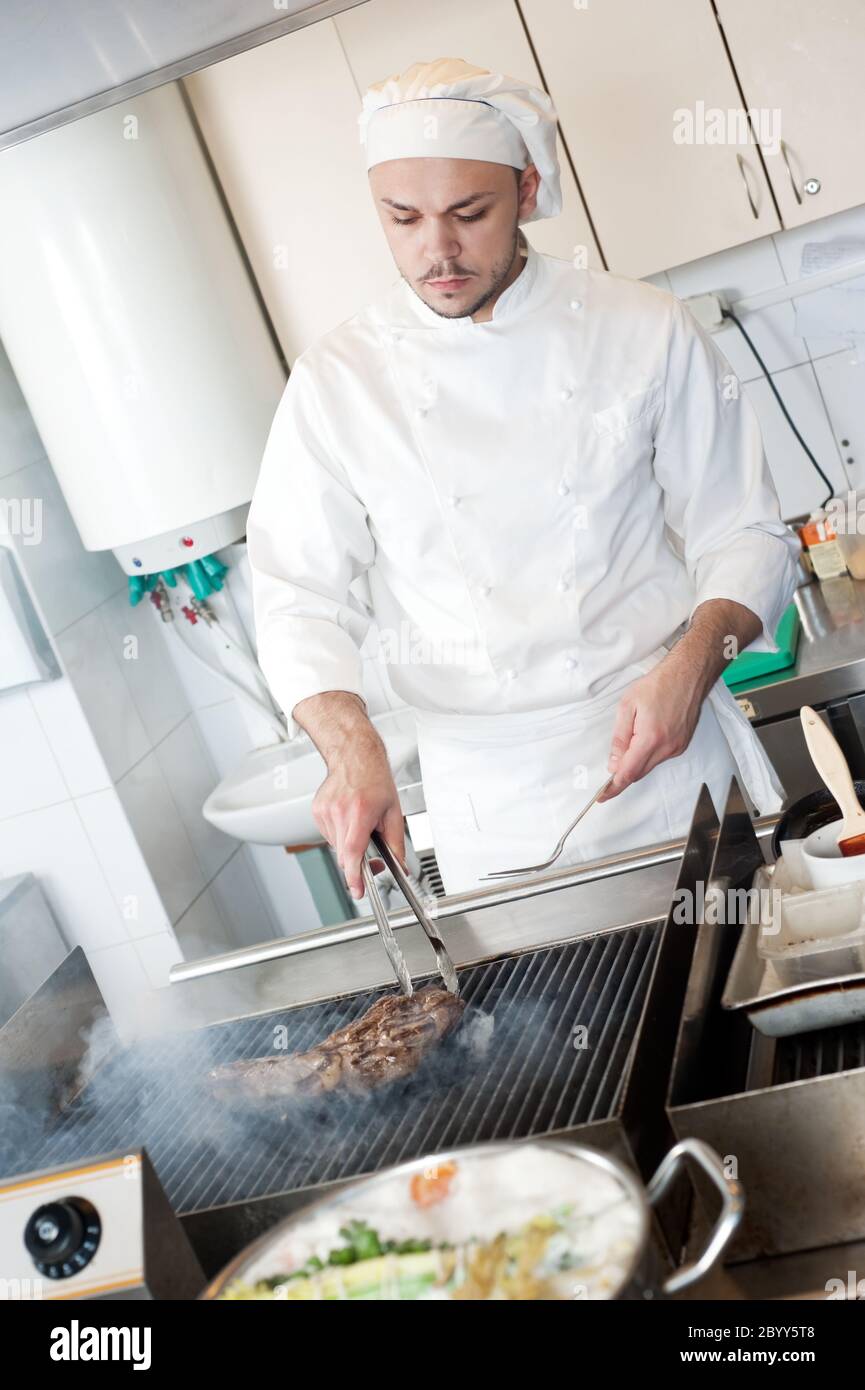chef frying beef steak on grill Stock Photo - Alamy