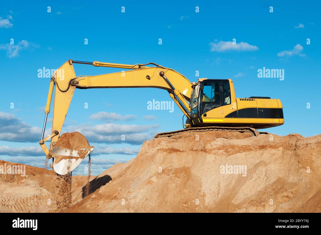 track-type loader excavator at sand quarry Stock Photo