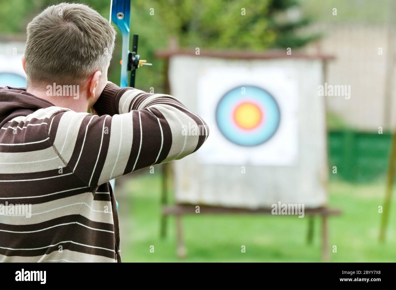 Archer aiming with bow Stock Photo