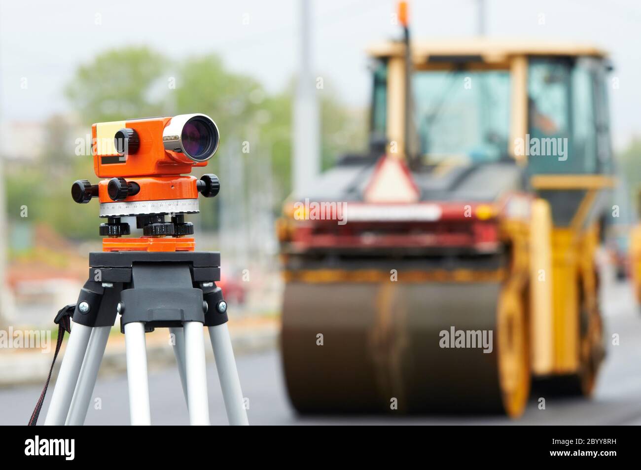 survey equipment at asphalting works Stock Photo