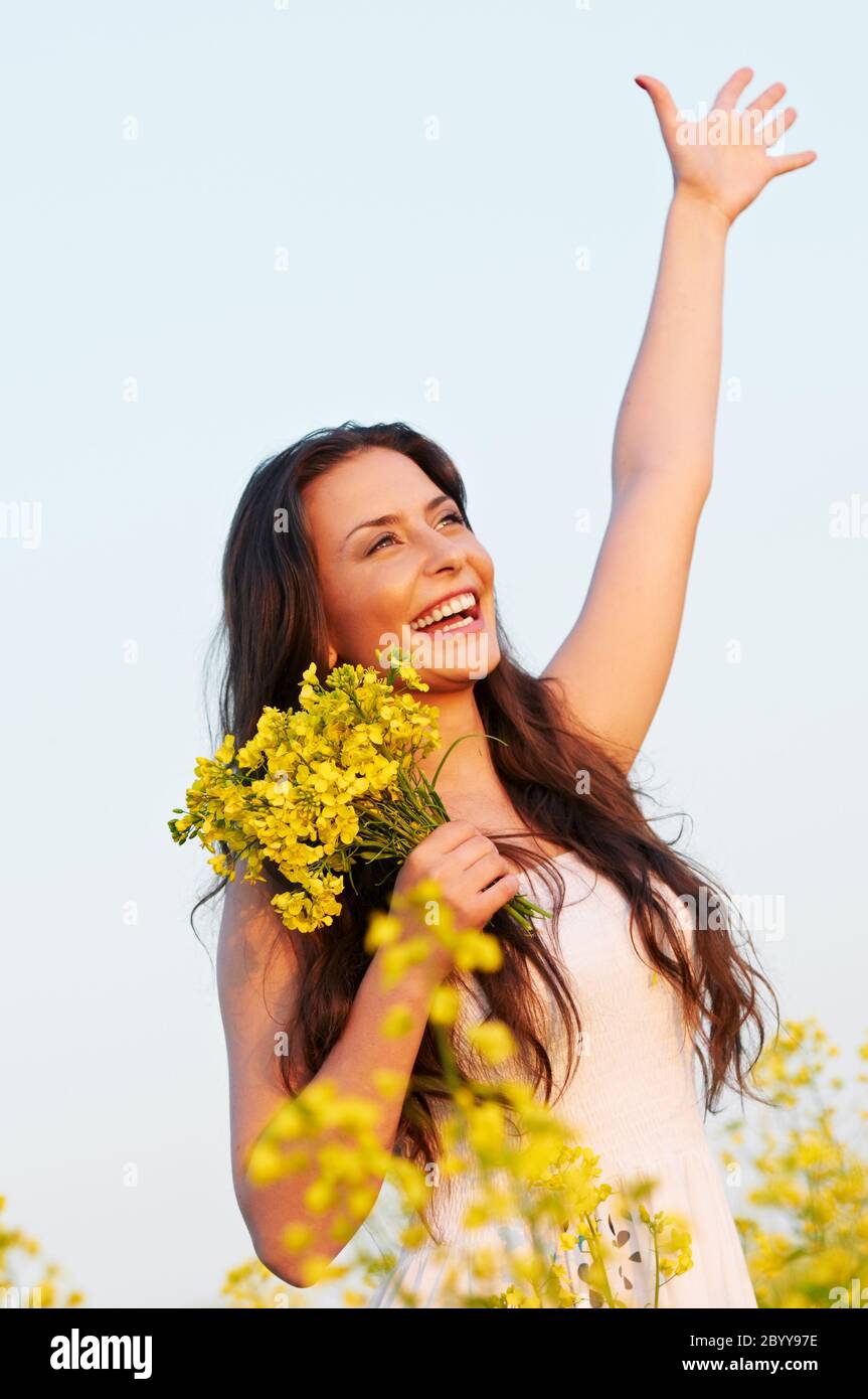 girl with flowers at summer field Stock Photo