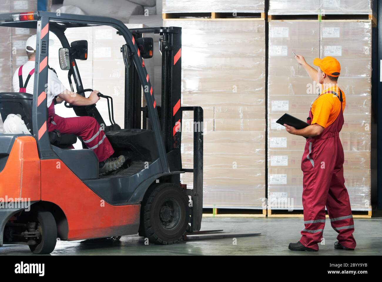 warehouse works (forklift and workers) Stock Photo