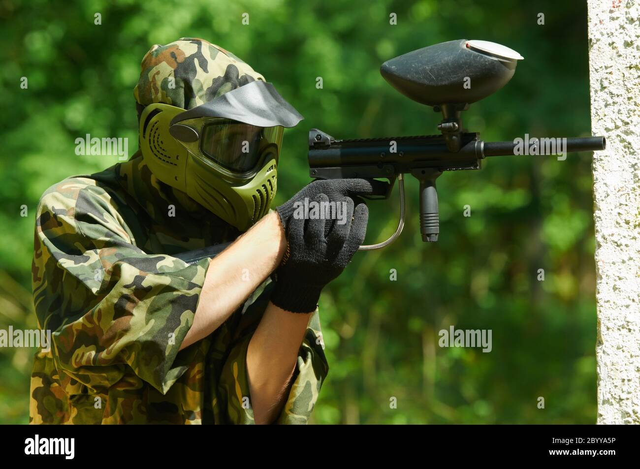 paintball player holding fire Stock Photo Alamy