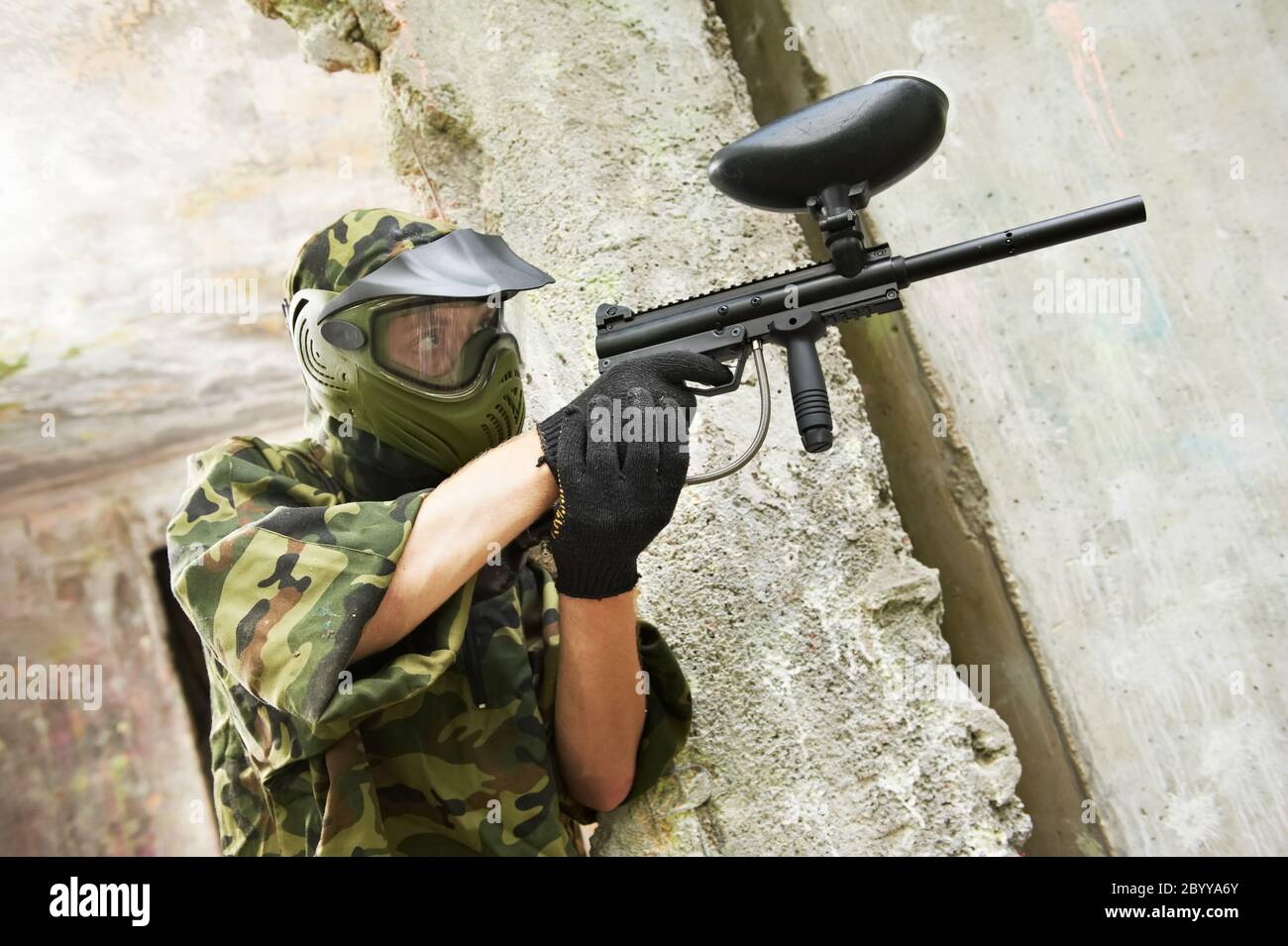 paintball player under cover Stock Photo Alamy