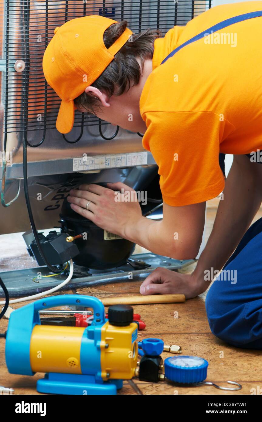 repair work on fridge appliance Stock Photo