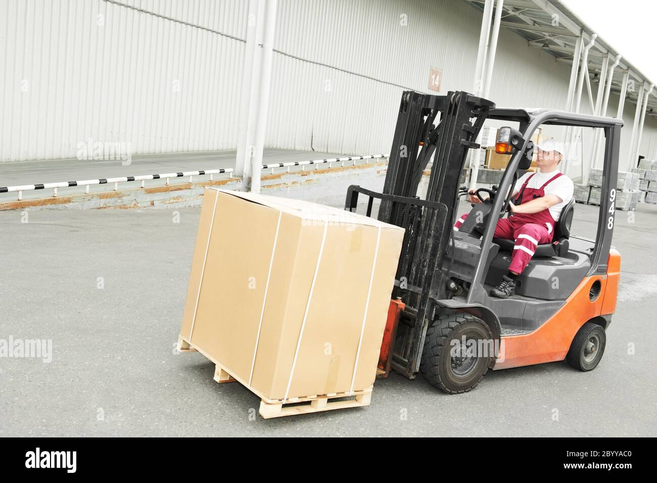 warehouse worker driver in forklift Stock Photo