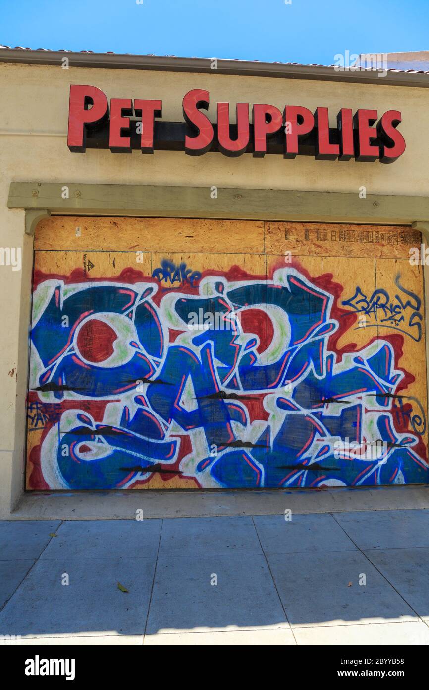 Painted murals protesting the murder of George Floyd on plywood boards covering storefront windows on Lincoln Blvd, Santa Monica, Los Angeles,  California Stock Photo
