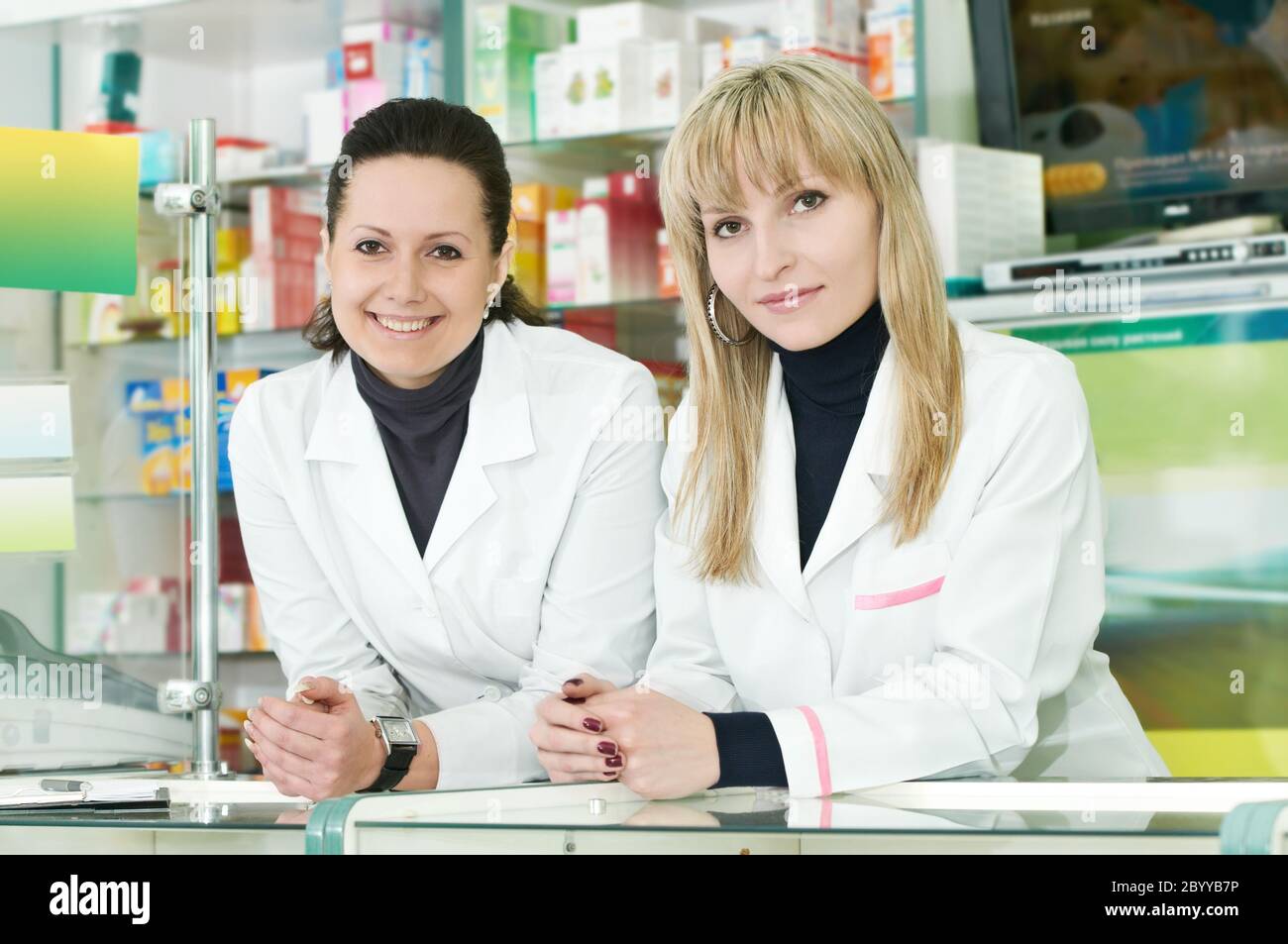 Two Pharmacy chemist women in drugstore Stock Photo