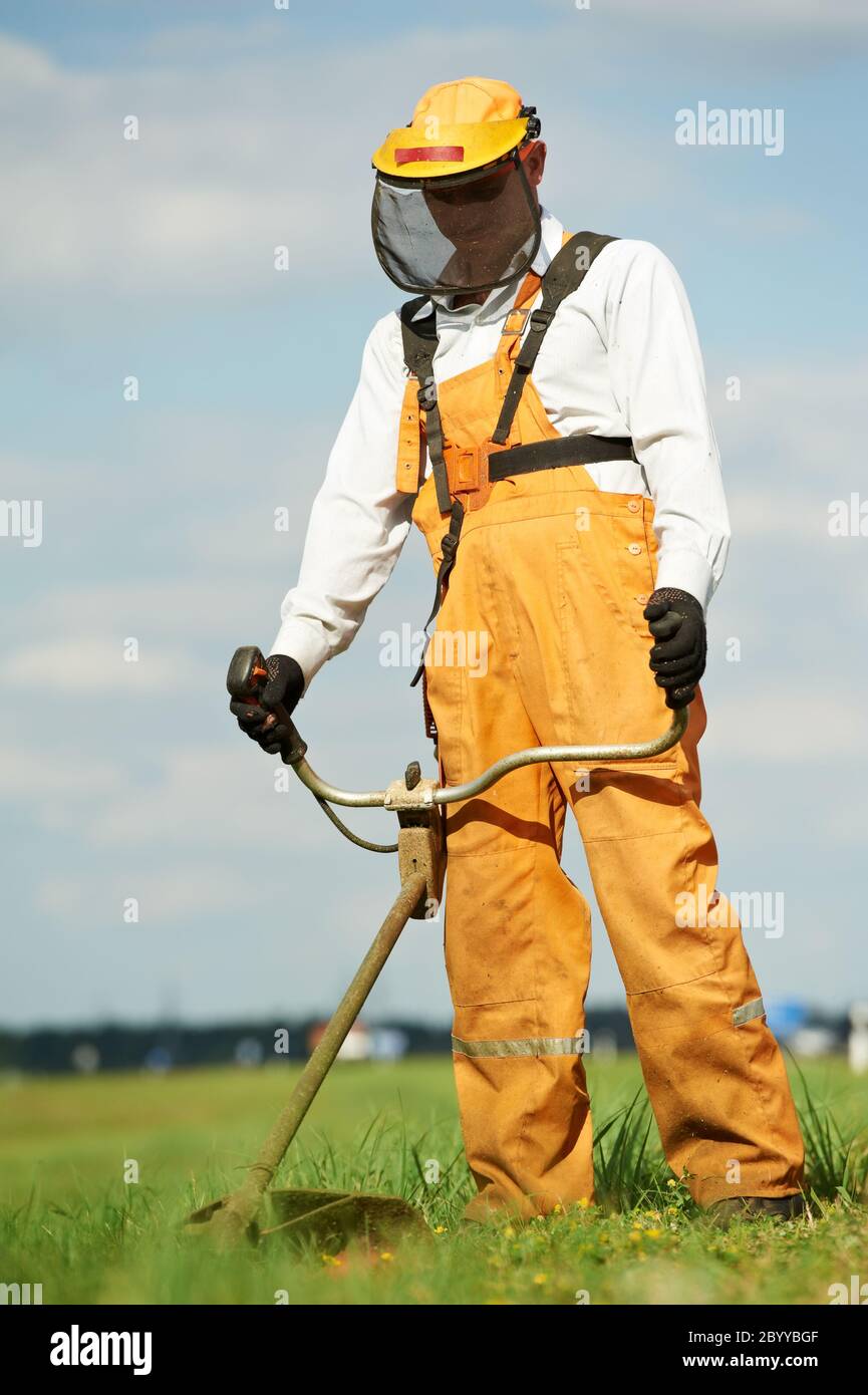 Grass trimmer works Stock Photo