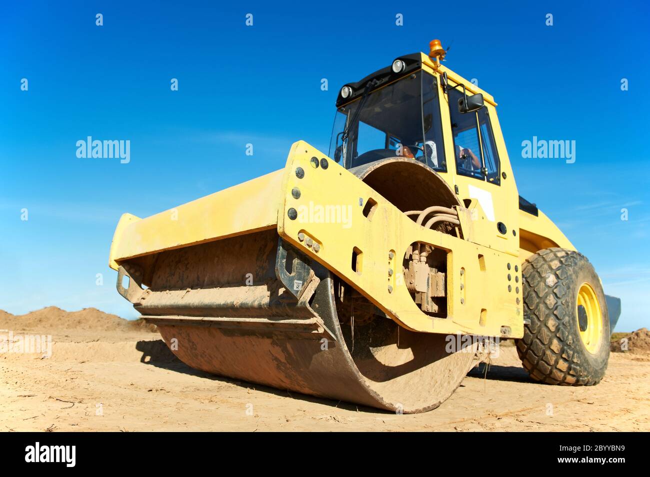 Compactor at road compaction works Stock Photo