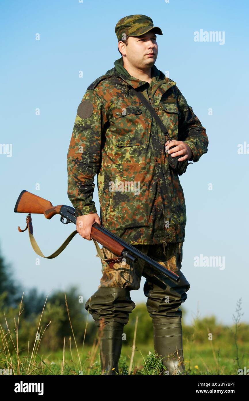 hunter with rifle gun Stock Photo