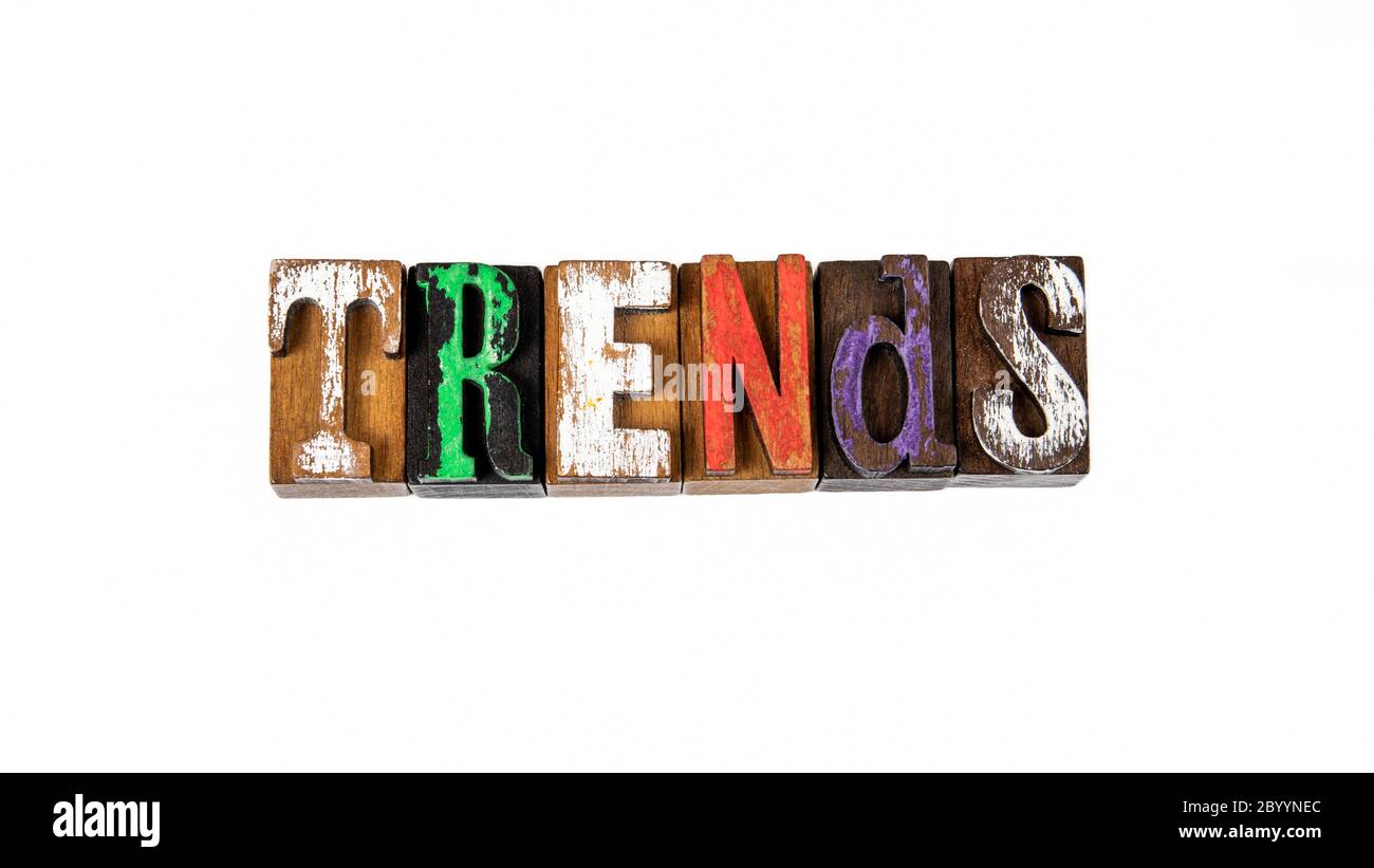 Trending Letters TRENDS. Colored wooden letters on a white background Stock Photo - Alamy