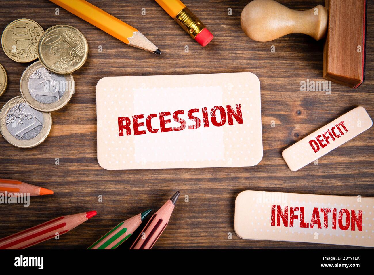 RECESSION, INFLATION and DEFICIT. Economic crisis, financial difficulties, falling investment and insolvency concept. Note sheet like medical plaster Stock Photo