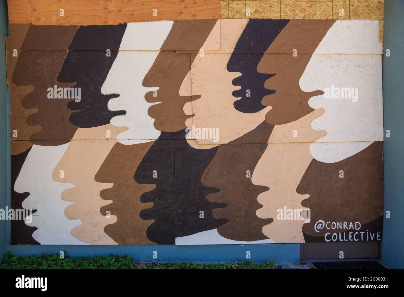 Painted murals protesting the murder of George Floyd on plywood boards covering storefront windows, Broadway, Santa Monica, Los Angeles,  California Stock Photo