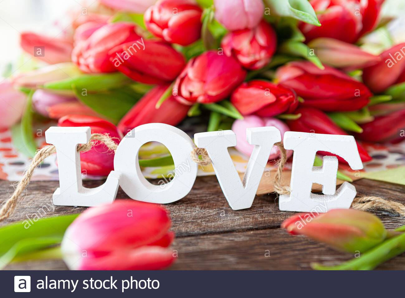 Fresh Colorful Tulips And Wooden Letters Spelling Love Stock Photo Alamy