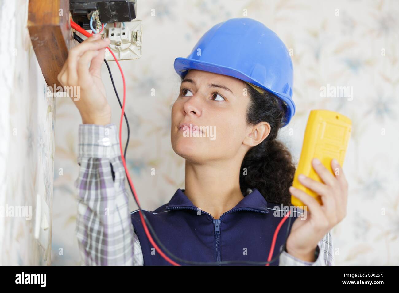 a woman measuring electrical current Stock Photo Alamy