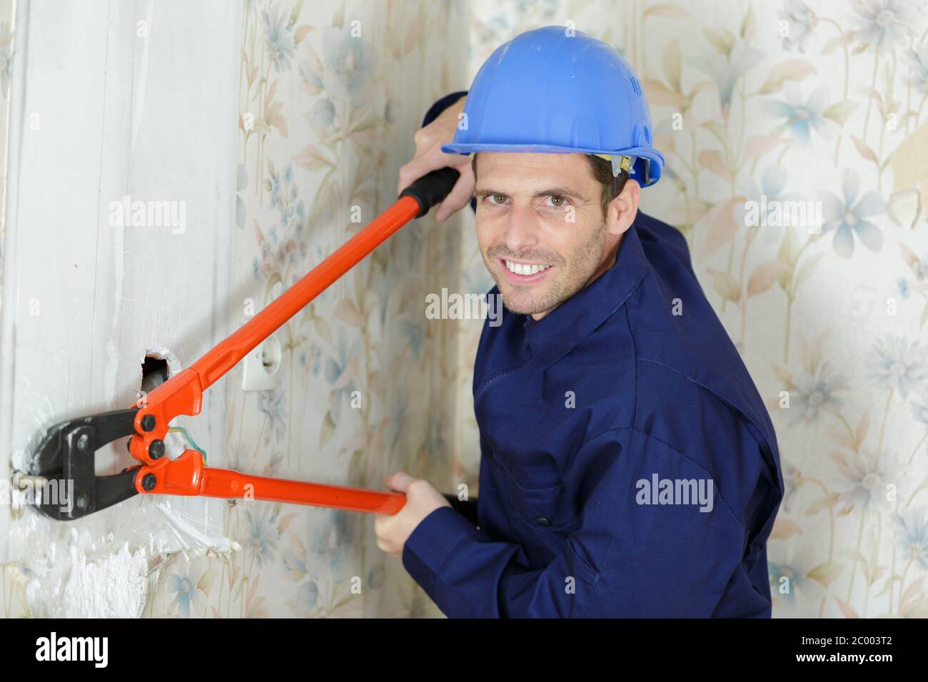 using a wire stripper tool with wall Stock Photo