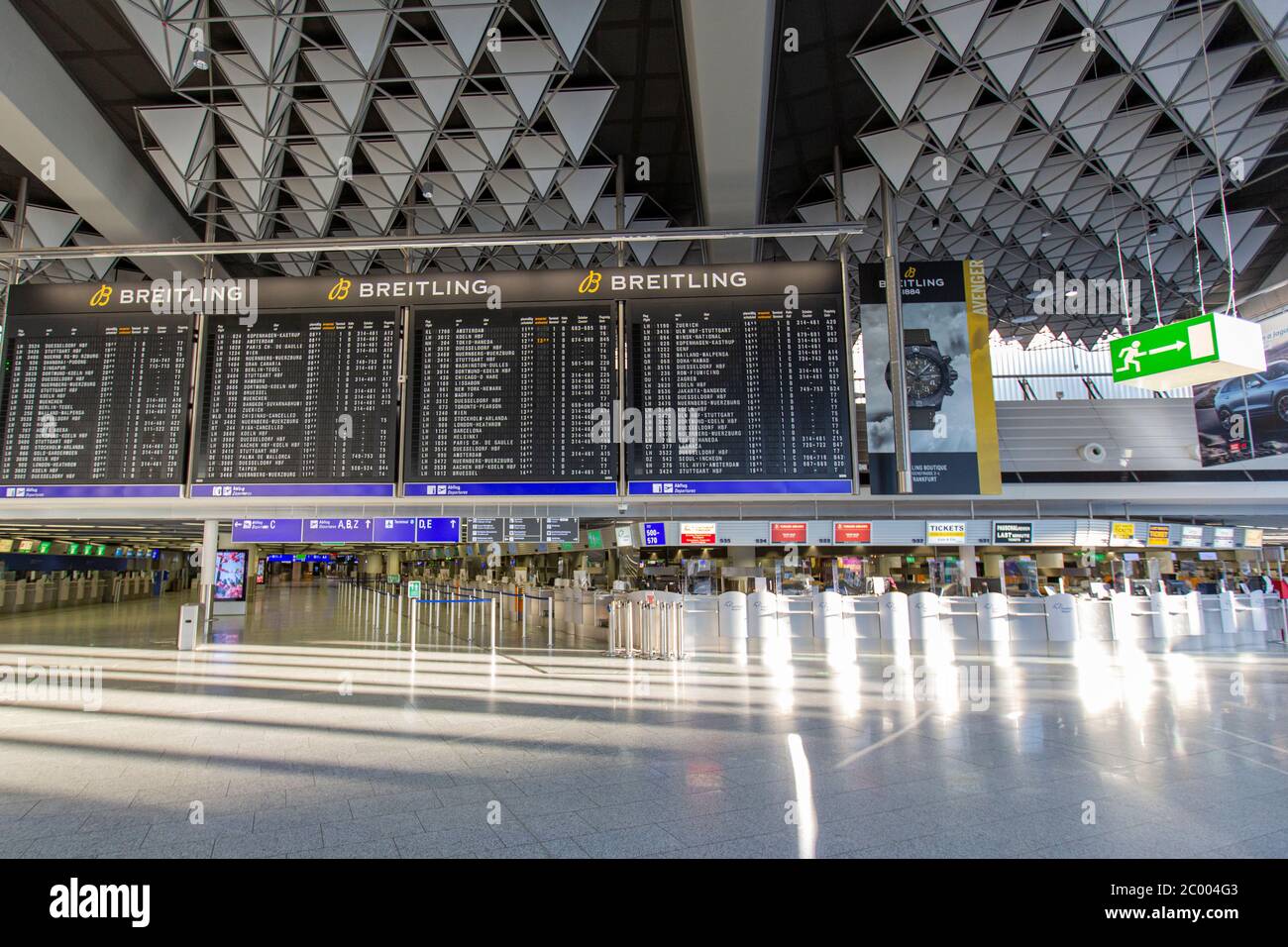 Deserted check-in area in the nearly empty Frankfurt Airport during the lockdown caused by the COVID-19 virus. Worldwide, the air traffic industry is heavily impacted by the massive drop in traffic. Stock Photo