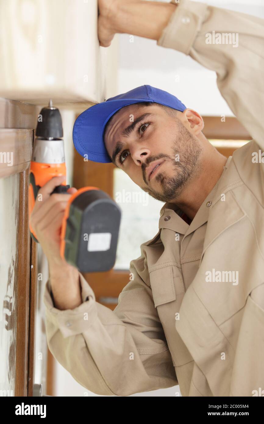 young builder using corless drill Stock Photo