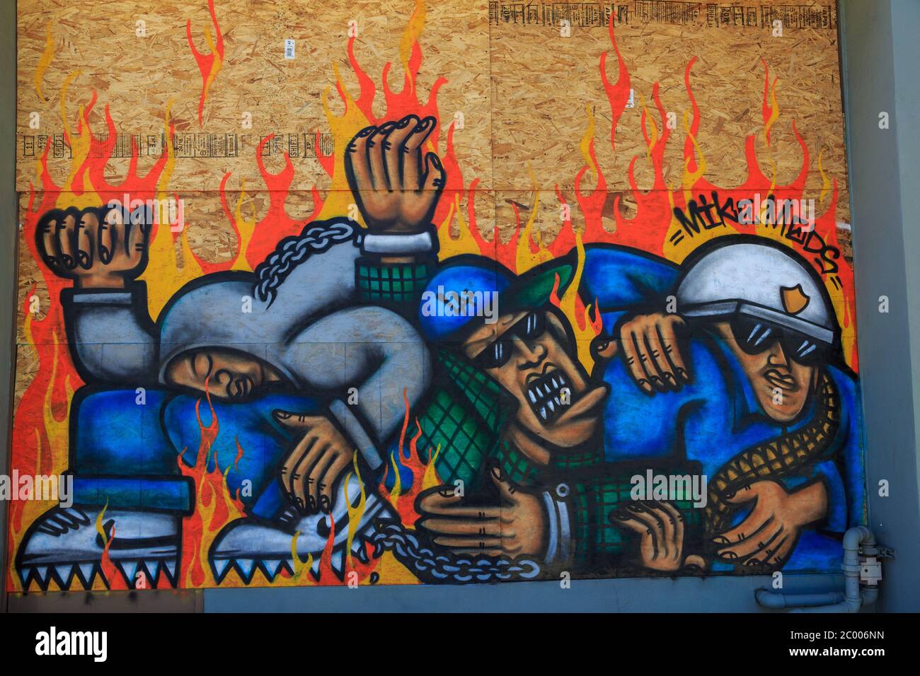 Painted murals protesting the murder of George Floyd on plywood boards covering storefront windows, Broadway, Santa Monica, Los Angeles,  California Stock Photo