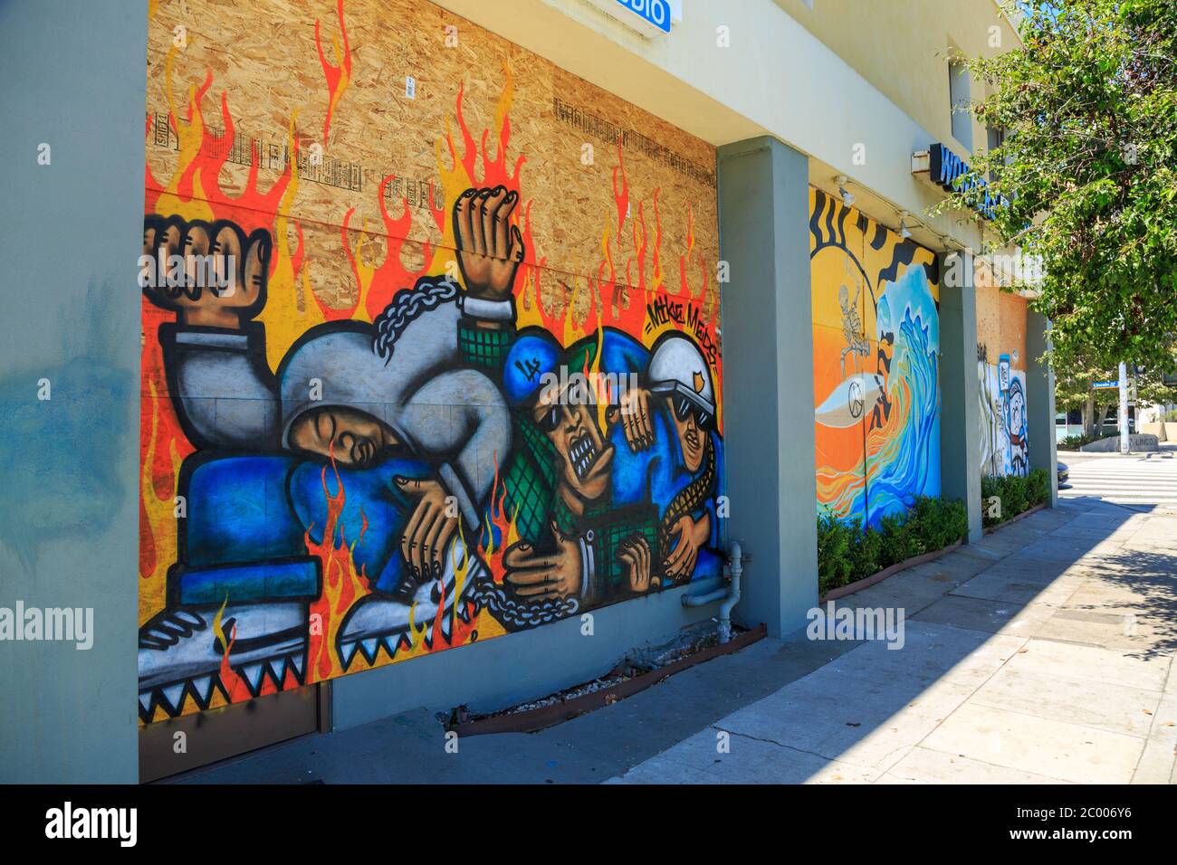 Painted murals protesting the murder of George Floyd on plywood boards covering storefront windows, Broadway, Santa Monica, Los Angeles,  California Stock Photo