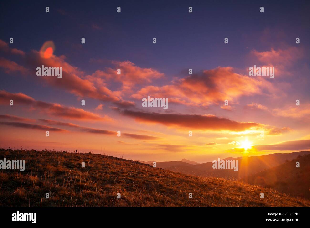 Sunset in mountains Stock Photo - Alamy