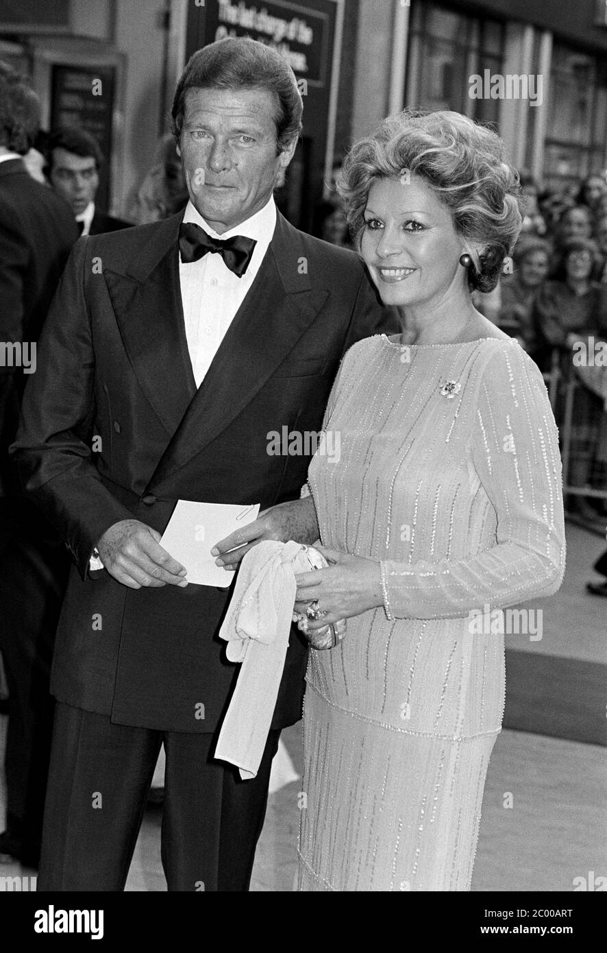 LONDON, UK. July 1980: Actor Roger Moore & wife Luisa Mattioli at the premiere of 'Sea Wolves' in London. © Paul Smith/Featureflash Stock Photo