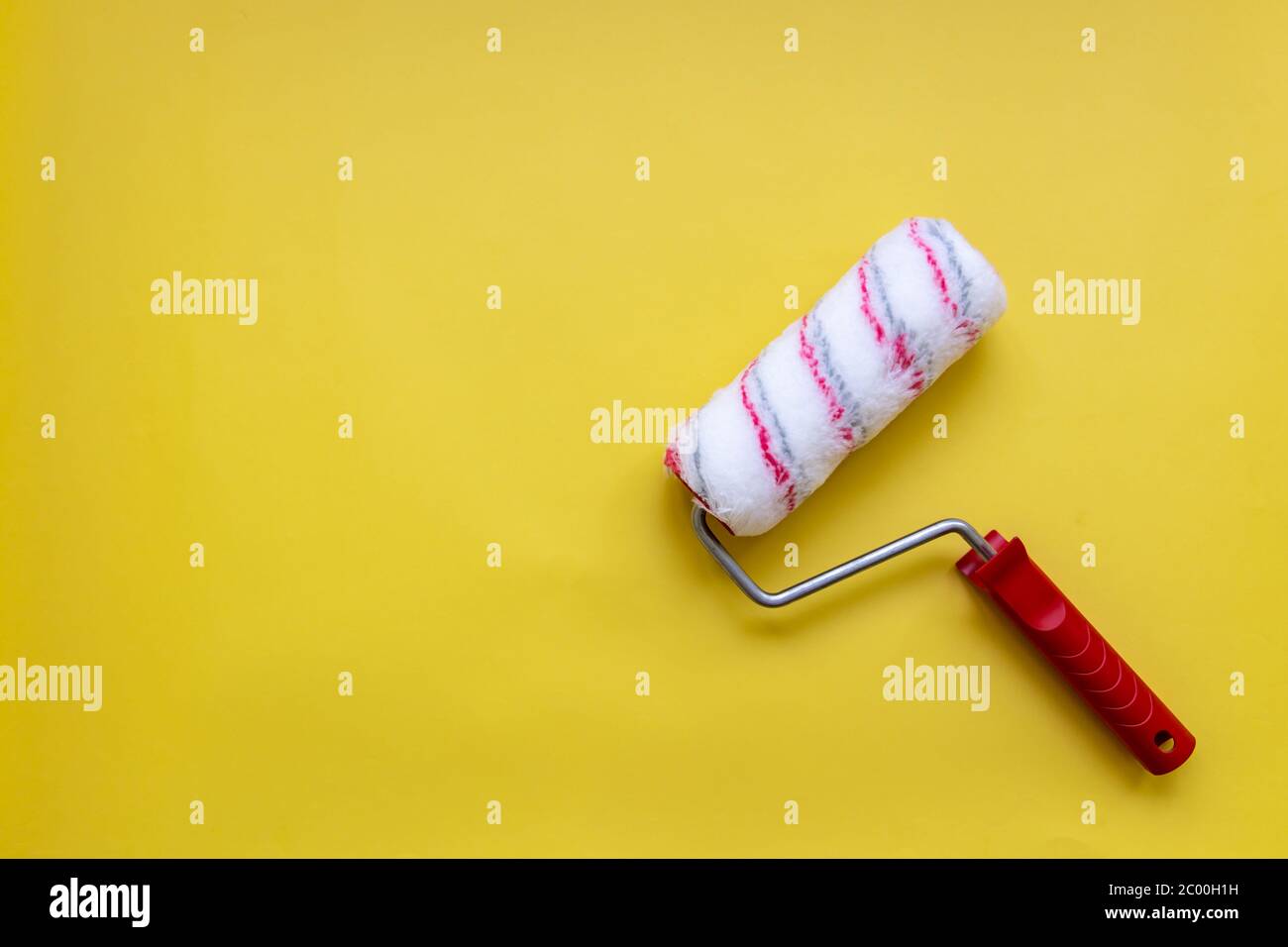 Paint roller for painting and priming new on yellow Background Stock