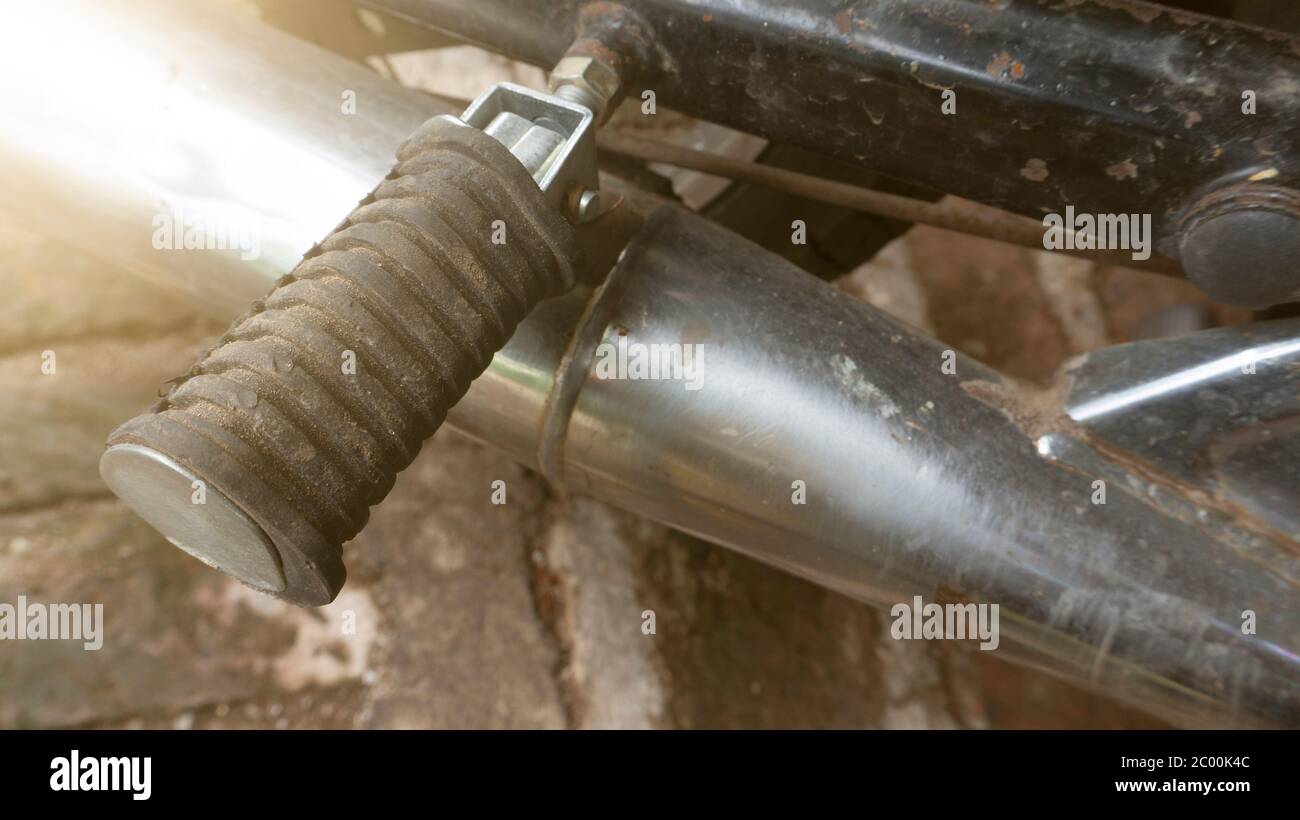 Motorcycle rear footrests, are above the pit hole Stock Photo