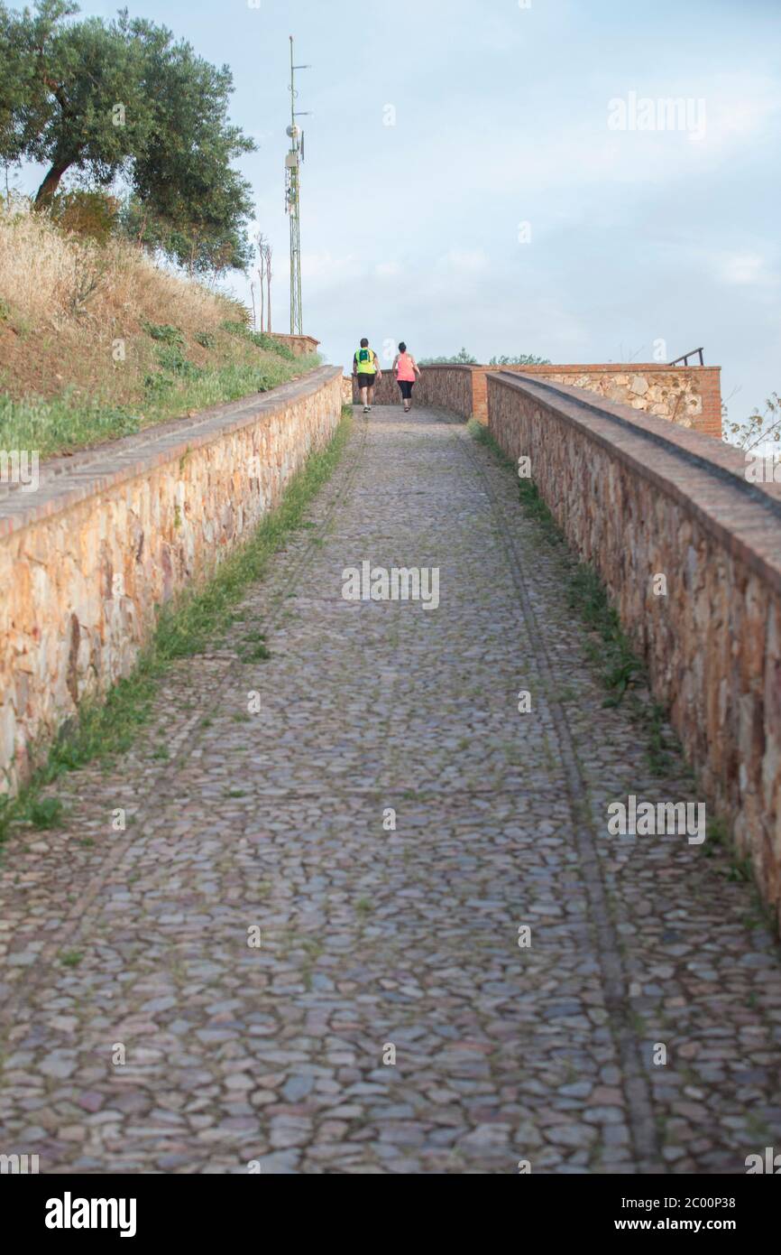 Hornachos, Spain - May 31st 2020: Couple ascending to Castle hill of Hornachos, Extremadura, Spain Stock Photo