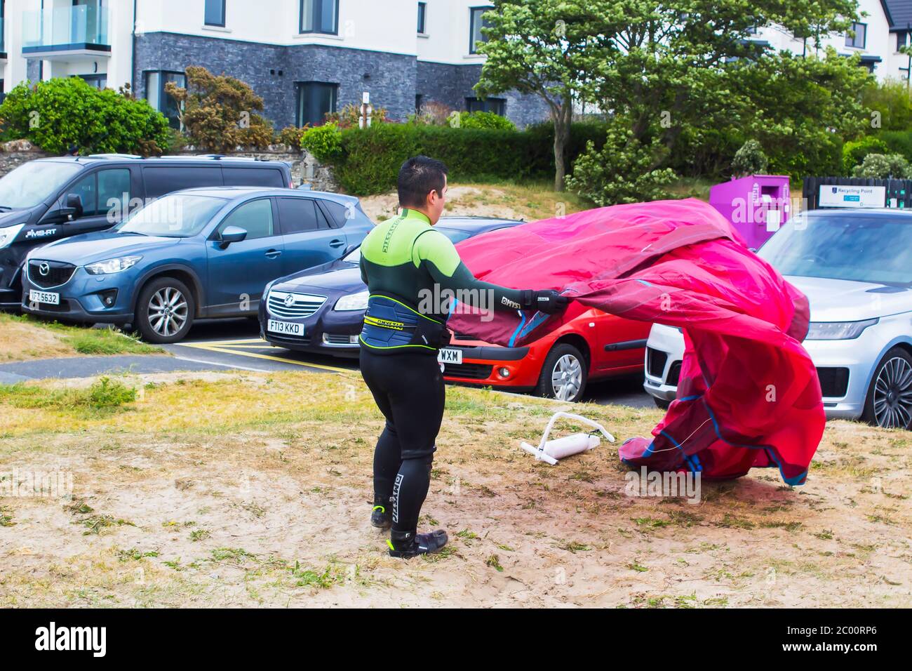 6 June 2020 Bangor, County Down, Northern Ireland, A young male in The Banks car park on the Groomsport Road, Ballyholme prepares his kiteboarding equ Stock Photo