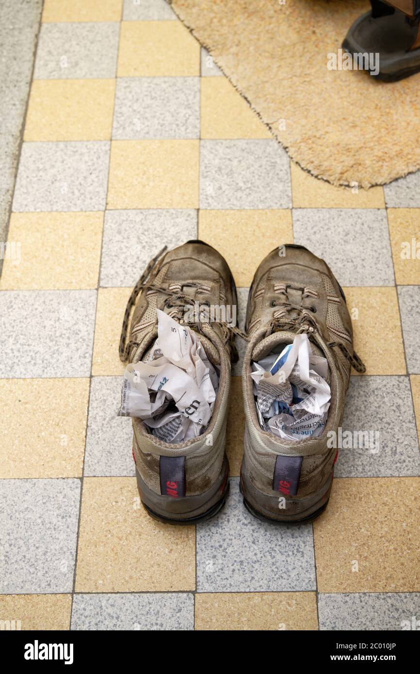 hiking boots air drying with newspaper