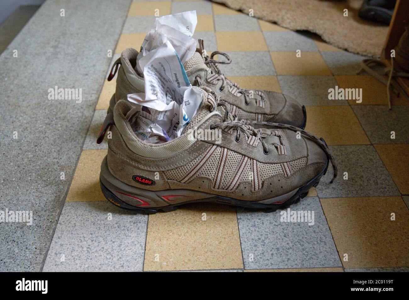 Drying hiking shoes with newspaper Stock Photo