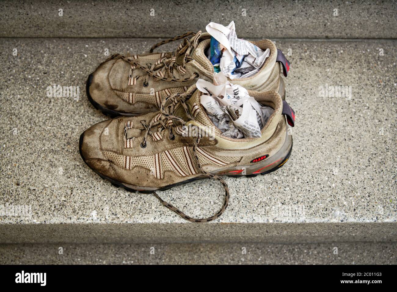 Drying hiking shoes with newspaper Stock Photo