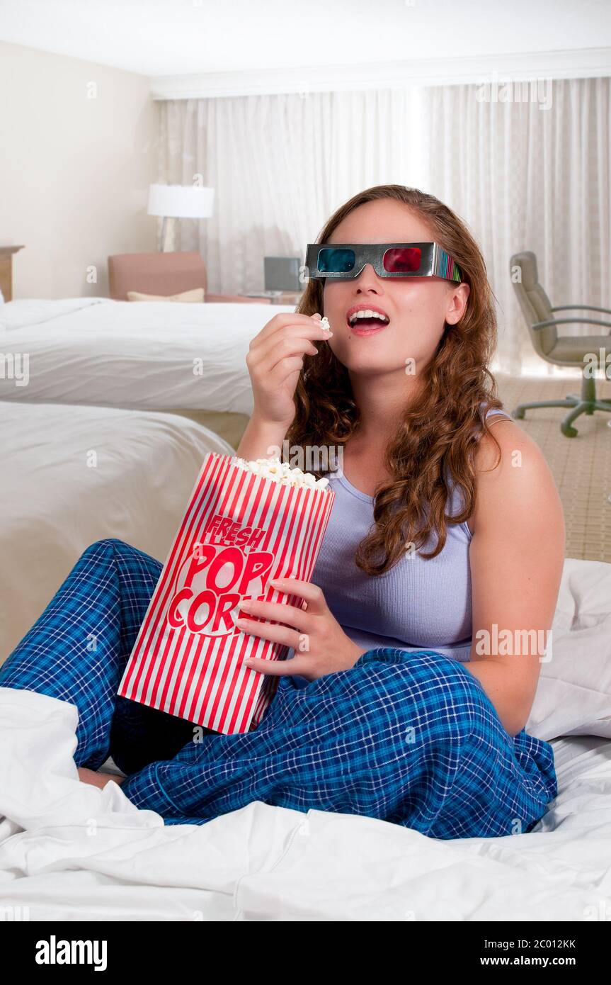 Woman in bed with popcorn Stock Photo Alamy