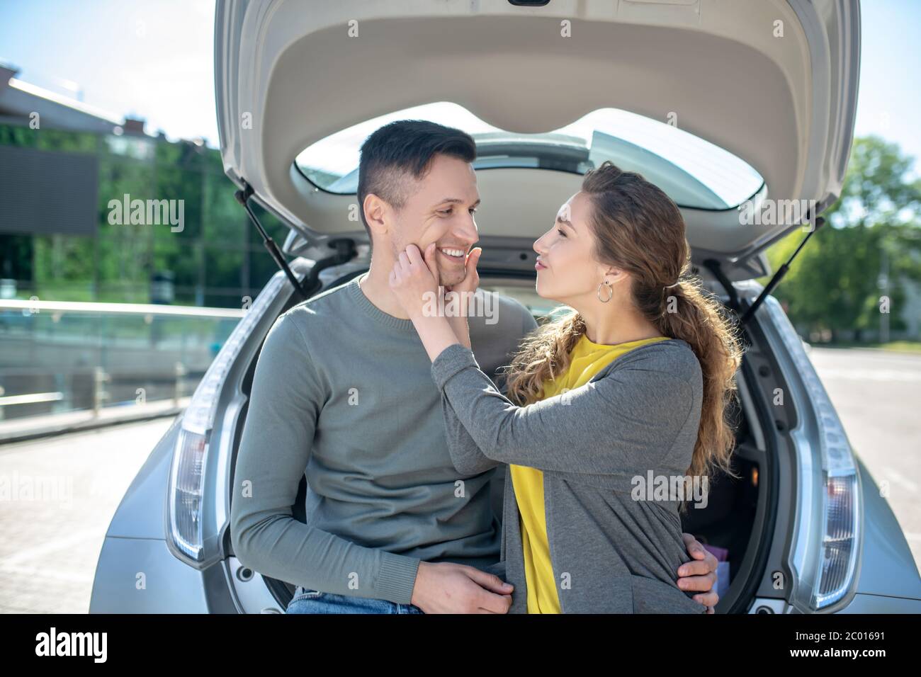 Young woman touching hands to mans face Stock Photo