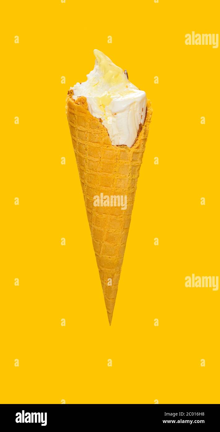 Side View Half Eaten Vanilla Flaovr Ice Cream Cone On A Yellow Background Stock Photo Alamy