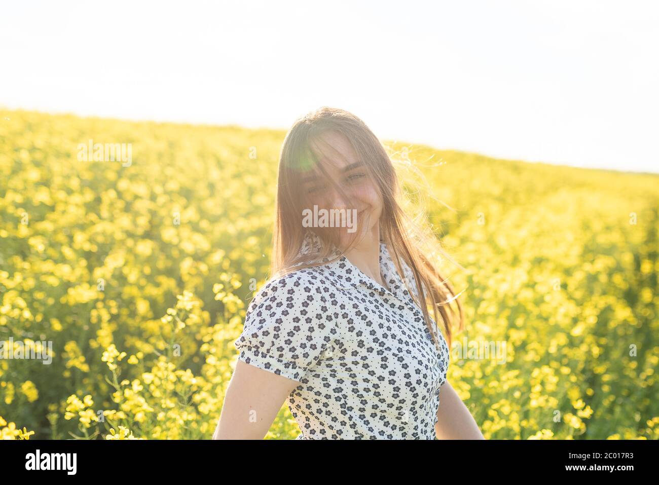 Beautiful girl in a rapeseed field, with her hair in the sun Stock ...