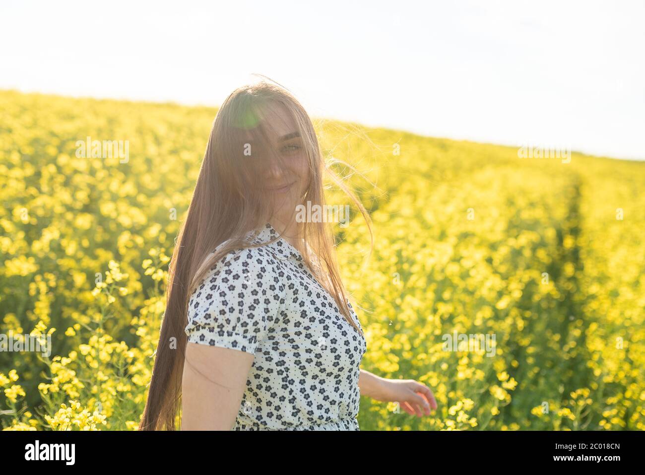 Beautiful girl in a rapeseed field, with her hair in the sun Stock ...