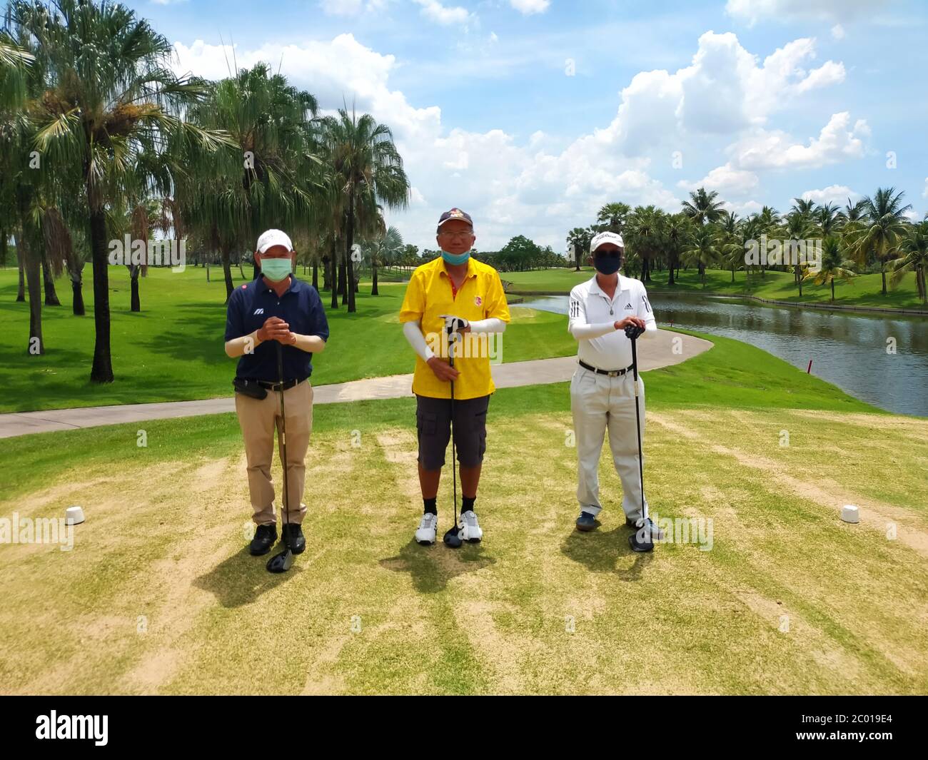Three friends start to play golf in a golf course Stock Photo Alamy