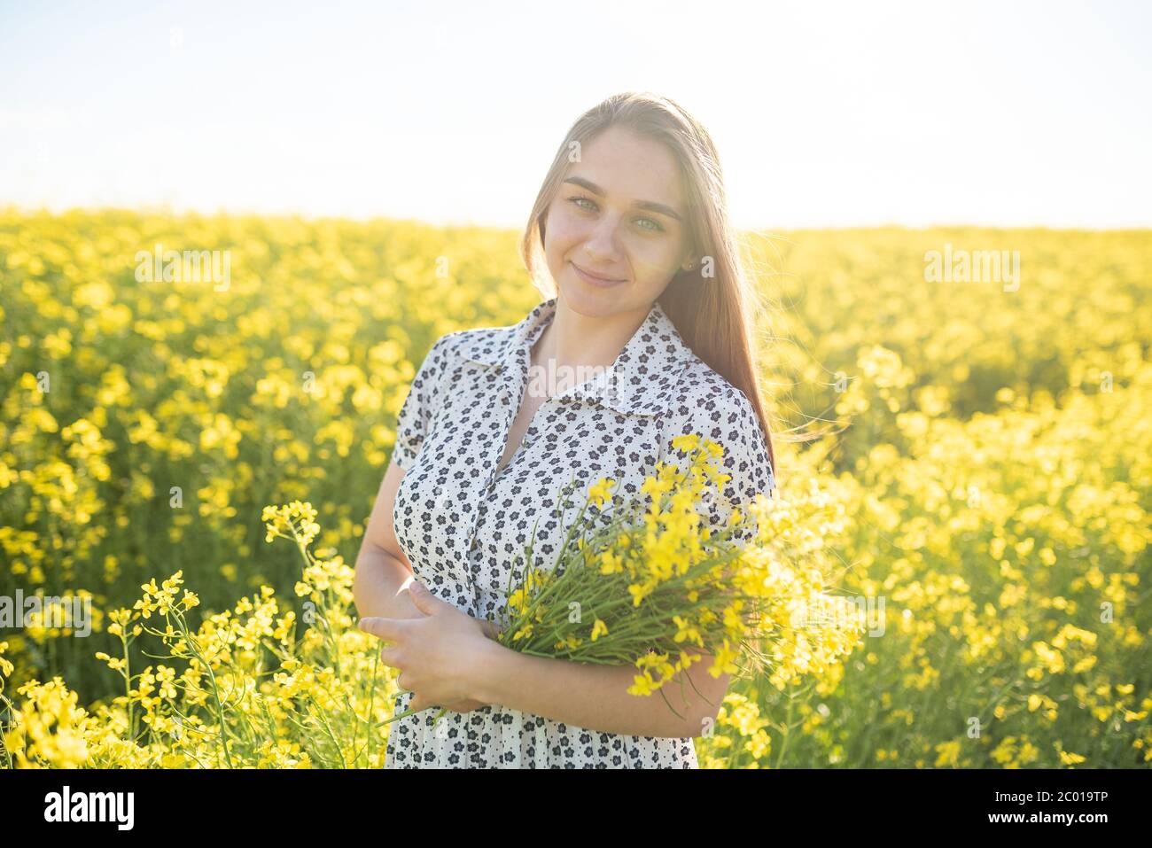 Beautiful girl in a rapeseed field, with her hair in the sun Stock ...