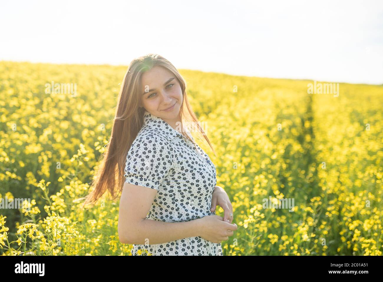 Beautiful girl in a rapeseed field, with her hair in the sun Stock ...