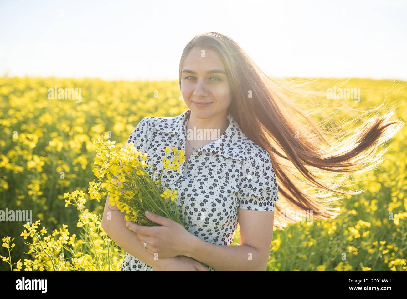 Beautiful girl in a rapeseed field, with her hair in the sun Stock ...
