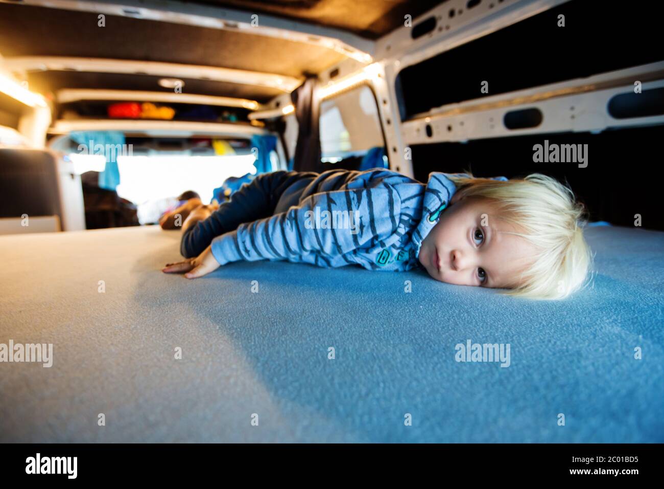 Children, having fun in camper van while heavy raining outdoors