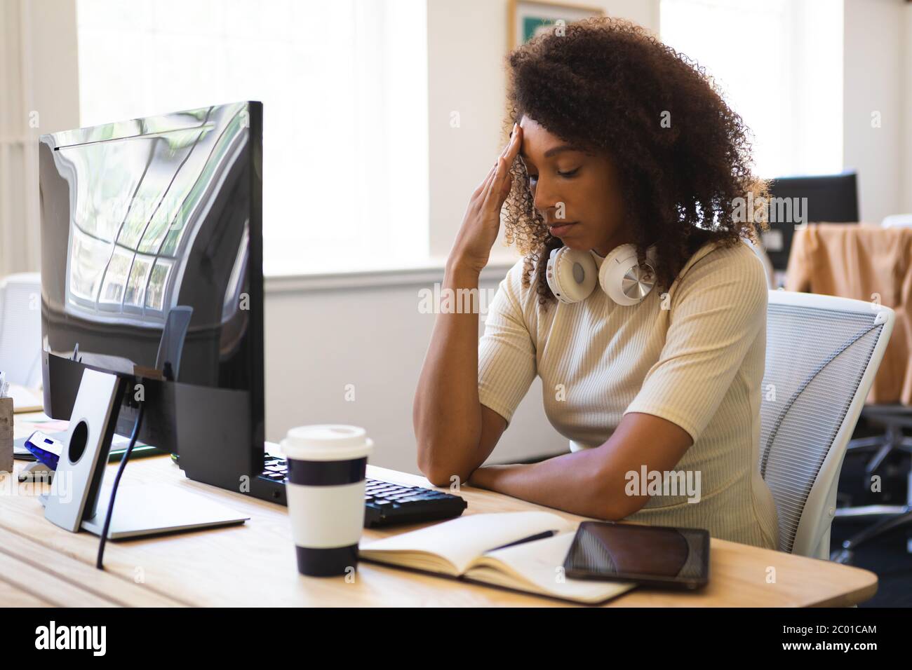 https://c8.alamy.com/comp/2C01CAM/mixed-race-woman-working-hard-on-computer-in-an-office-2C01CAM.jpg