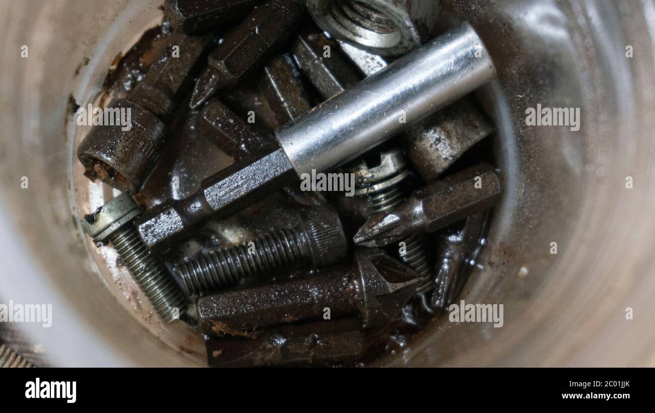 Various used bolts that are wet with oil, how to store metal so it does