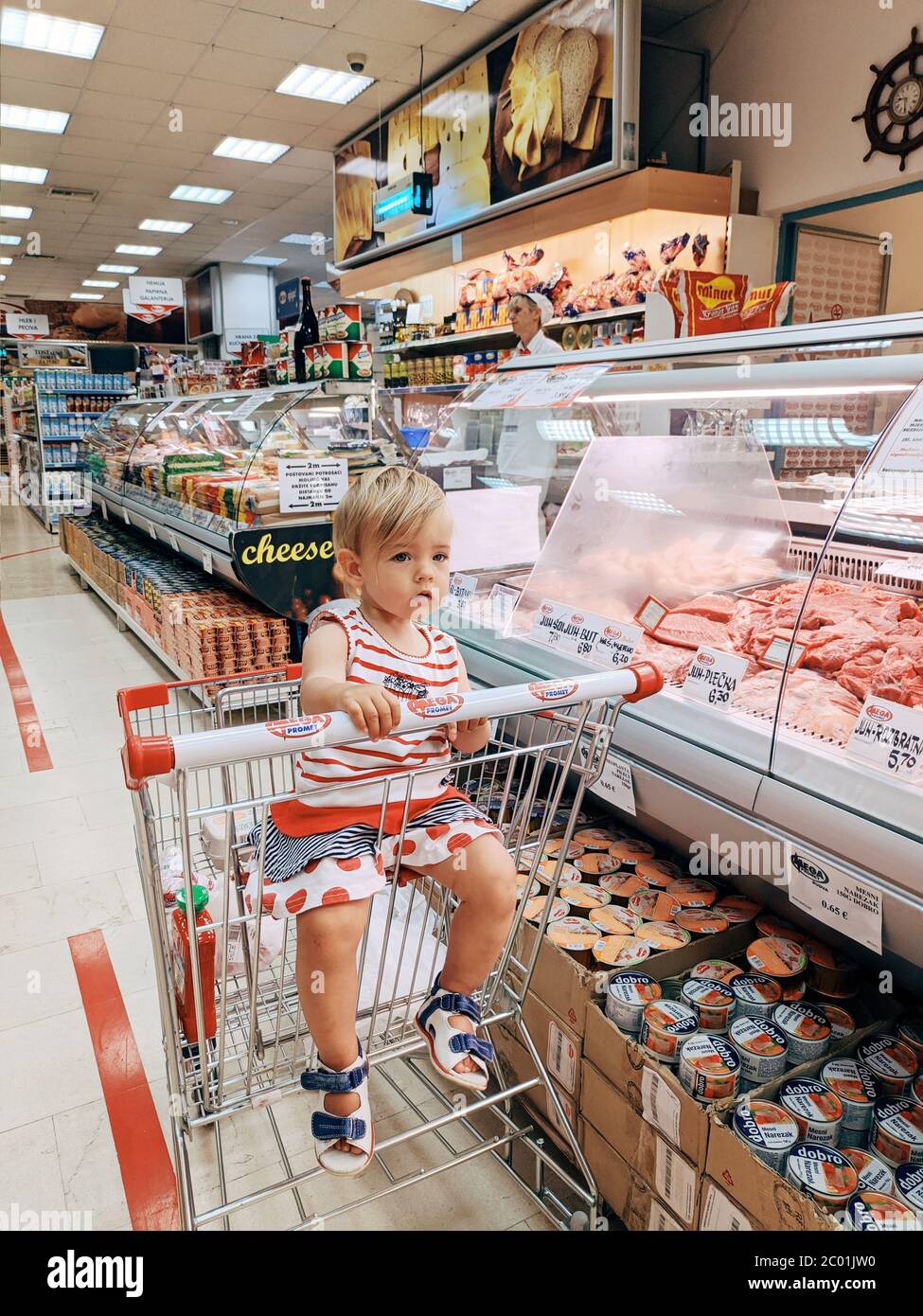 Budva Montenegro 10 June A One Year Old Child Girl Sits In A Supermarket Trolley In The Meat Department Stock Photo Alamy